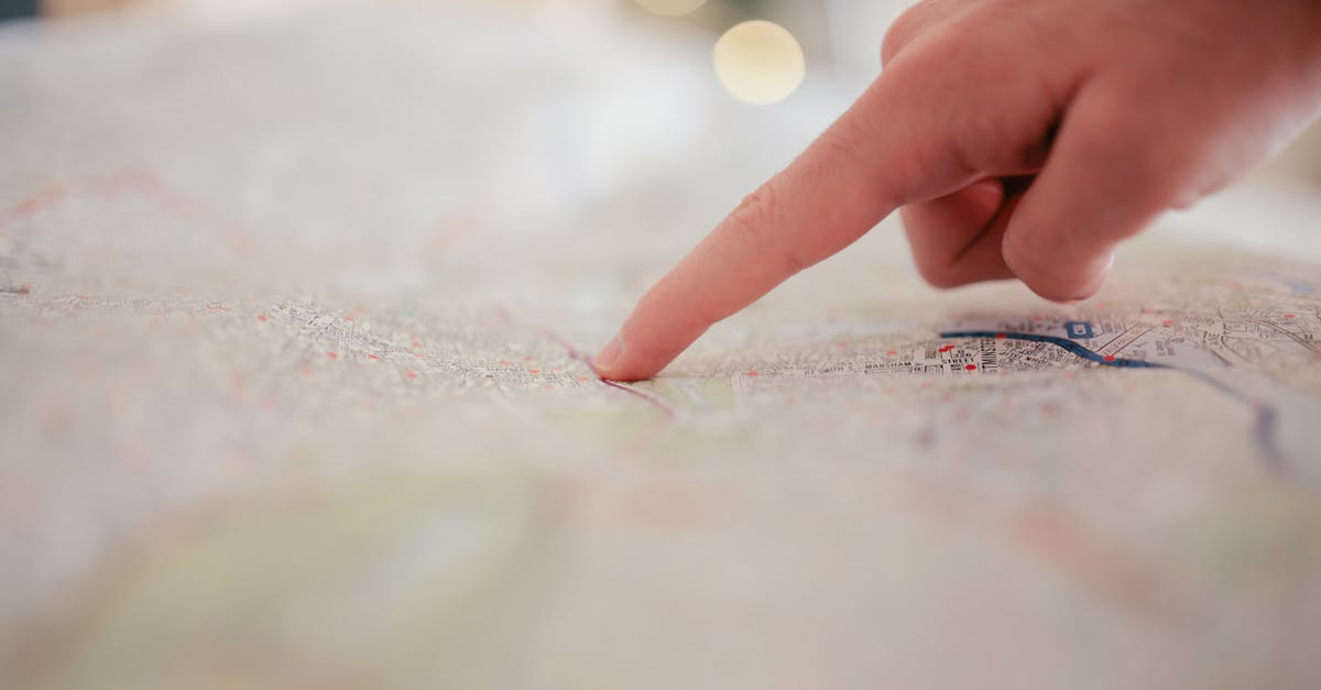 A hand pointing at a city map, highlighting direction and navigation planning.